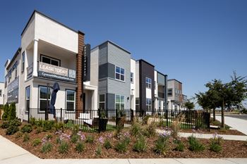 A modern apartment complex with a sign that says "LEASE TODAY" is shown.